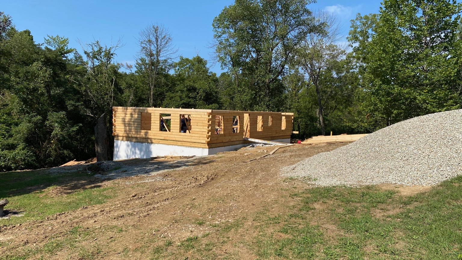 Current log home project exterior with log walls going up